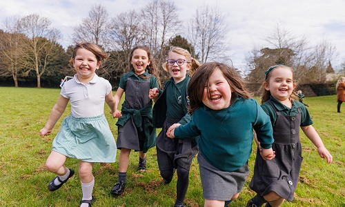 Ysgol Gymraeg Trefynwy pupils running and laughing